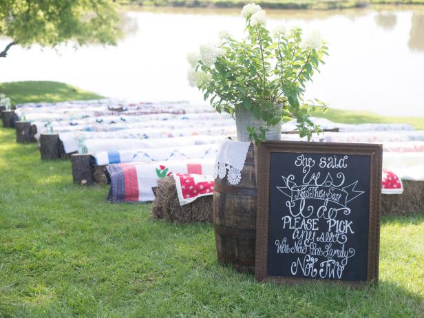 DIY Chalkboard Sign Leading to Quilt Covered Rows of Hay Bail Seating for Outdoor Country Wedding DIY Chalkboard Sign Leading to Quilt Covered Rows of Hay Bail Seating for Outdoor Country Wedding