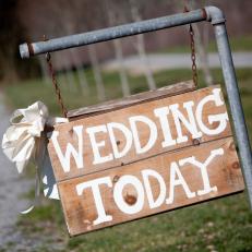 Wooden Wedding Welcome Sign With Cream Paint Print Hung on Metal Piping 
